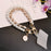 Pearl Wrist Phone Lanyard with Hand-Woven Leather & Floral Accent